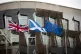The Union flag, Saltire and EU flag fly outside the Scottish