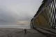 A boy walks near where a border wall separating the United S
