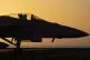 A fighter jet maneuvers on the deck of the USS Dwight D. Eis