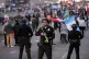 Police stand during an immigrant rights protest, February 3,