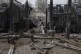A worker of DTEK company walks in front of transformers of a