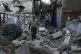 A Palestinian man inspects the damage to a building after Is