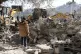 Heavy equipment clears rubble at the site where Israeli forc