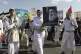 Houthi supporters raise a poster of the late Hezbollah leade