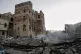Locals inspect the site reportedly struck by U.S. airstrikes