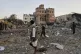 Locals inspect the site reportedly struck by US air strikes 