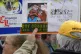An anti-vaccination protester in a hat bearing the name of t