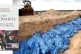 HORROR IN GAZA: Palestinians pray over a mass grave, in Khan