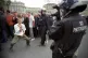 An anti-capitalist protester taunts a police camera team, 1 