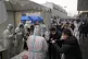 Medical workers scan codes on people's smartphones at a mass