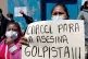 A woman holds a placard 