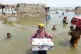 CLIMATE COLLAPSE: Women salvage whatever they can in the Qam