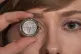 A Royal Mint worker holds up a commemorative Frankenstein co