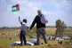 A young boy waves a Palestinian flag