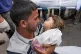 NO ONE IS SAFE: Karam Harara holds the body of his two-year-
