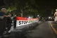 Demonstrators hold a banner in support of Palestinians in th