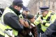 AGGRESSIVE INTERVENTION: Police officers detain a protester 