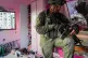 GROUND INVASION: An Israeli soldier stands in a Palestinian 
