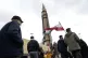 Iranian demonstrators march next to a domestically-built mis