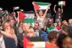 Delegates wave Palestinian flags at the Labour Party's annua
