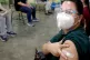 A health worker gives the ‘V’ sign after getting China's