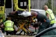 Ambulance staff take a man from outside a mosque in central 
