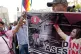 VOX POPULI: Anti-government protesters with a placard ‘Din
