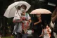 TURMOIL AHEAD: People walk in the rain ahead of the approach