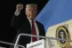 President Donald Trump gestures as he boards Air Force One a
