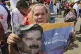 A supporter of Venezuela's Bolivarian revolution holds a por
