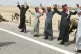 Iraqi men are frisked at gunpoint by soldiers of the 1st Bat
