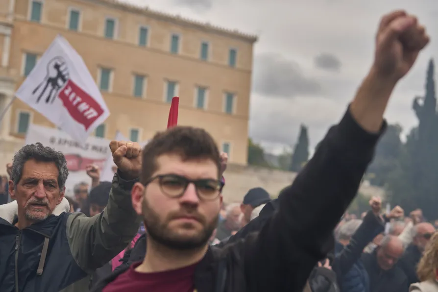 Protester raise their fists during a rally organized by the communist party-affiliated PAME to mark May Day outside the Greek parliament in Athens, on Friday, May 1, 2026